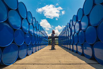 Wall Mural - Male worker inspection drum oil stock barrels blue