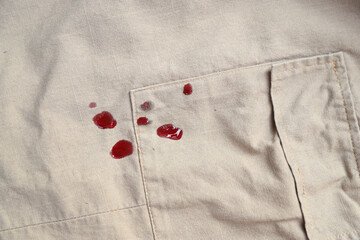 Wall Mural - Dirty blood stain splash on cloth fron using sharp knife in cooking. dirty stain for cleaning concept.