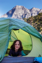 Family Vacation And Travel. Joyful Boy Lies In A Tent. Travel With Children. Hiking In The Forest And Living In A Tent.