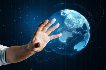 Wall Mural - Close up of male hand using glowing blue polygonal globe on blurry background. Global technology and metaverse concept.