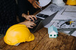 © ARMMY PICCA - Construction and structure concept of Engineer or architect meeting for project working with partner and engineering tools on model building and blueprint in working site, contract for both companies.