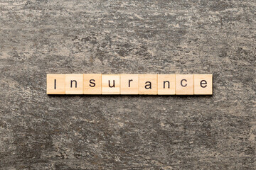 Wall Mural - insurance word written on wood block. insurance text on table, concept