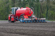A slurry injector planting maize on arable land in the east of the Netherlands in spring
