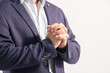 © CesarAntonio - crossed hands of young caucasian executive man. detail plane of the hands. White background. Blue suit