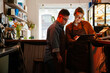 © Drobot Dean - Woman teaching man with down syndrome how to use tablet during internship in cafe