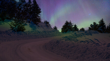Wall Mural - beautiful winter landscape with snow and ice covered road - northern lights (aurora borealis) in the