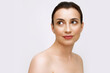 © Lustre Art Group  - Close up shot of attractive woman with perfect skin looking away with light smile over white studio background. Cosmetology