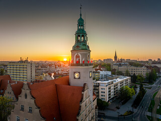 Wall Mural - Olsztyn - the town hall decorated with white and red flags at sunrise