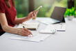© jat306 - Concept of business office woman working,Closeup businesswoman checking her invesment plan with analyzing document and business investment graph data by using calculator and laptop