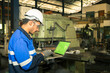 © atitaph - Portrait of worker, technician, professional engineer, helmet, using laptop, with control in production line.
