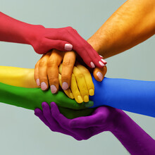 Closeup Hands Painted In Different Colors As Rainbow Flag Holding Together Symbolizing Tolerance Unity Love, LGBT On Light Background. Freedom Of Choice