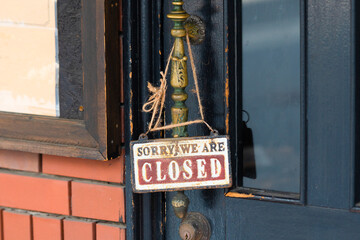 Wall Mural - sorry we are closed sign hanging outside a restaurant, store, office or other