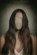 woman suffering from mental disorder , conceptual image of girl hiding  her face ,depression or low self esteem .