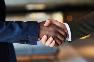 Poster - Close-up of handshake of young intercultural male delegates greeting one another at meeting before discussing points of new project