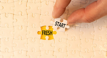 Wall Mural - Fresh start and motivational symbol. Concept words Fresh start on white puzzles. Beautiful yellow table yellow background. Businessman hand. Business motivational and Fresh start concept. Copy space.
