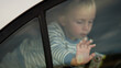 © OLEKSANDR - Child trapped in a car on a hot day. Conceptual image of overheating danger in the car for young children in summer