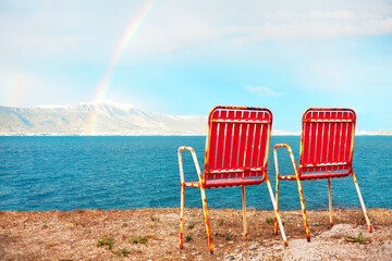 Wall Mural - Two seats at seaside . Rainbow over the sea . Seats for two 