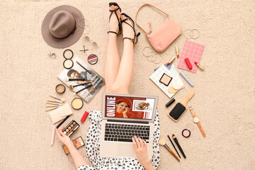 Wall Mural - Woman with laptop and accessories shopping online on beige carpet