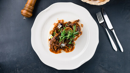 Sticker - Dinner beef tongue medallions with sauce and microgreens.