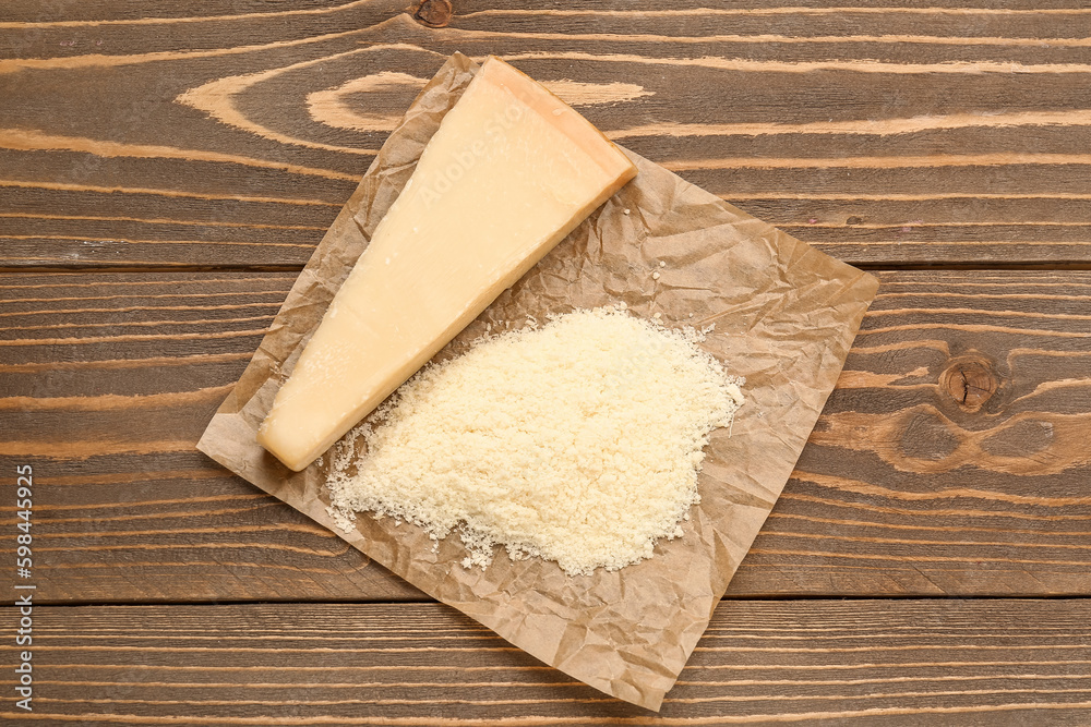 Tasty Parmesan cheese on wooden background