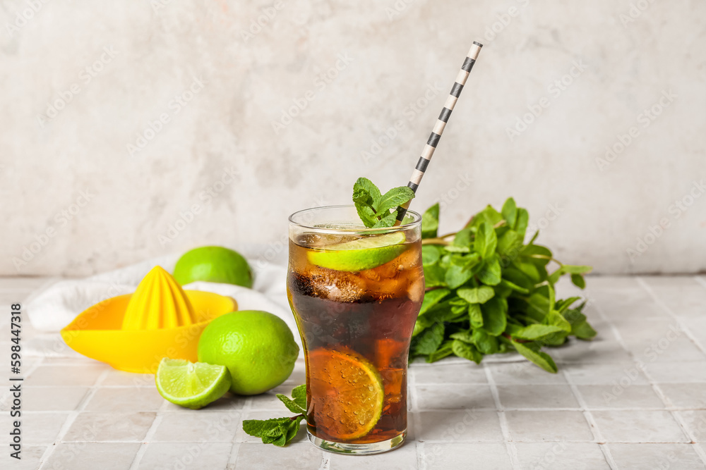 Glass of tasty Cuba Libre cocktail on table