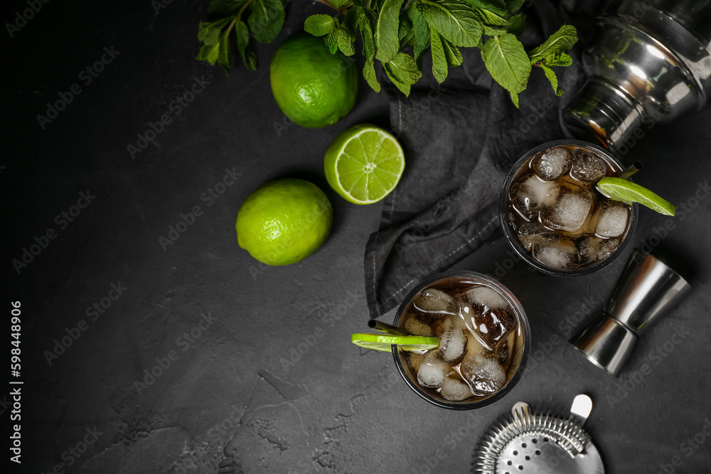 Glasses of cold Cuba Libre cocktail on dark background