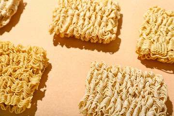 Raw instant noodles on beige background