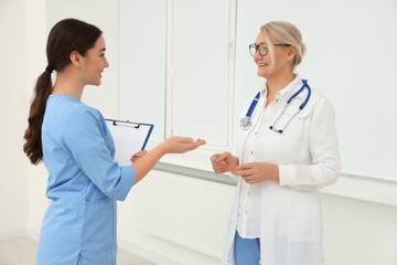 Sticker - Medical doctors in uniforms having discussion indoors