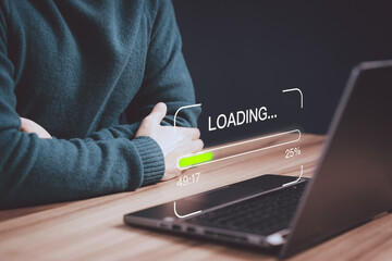 Poster - Young man using a laptop computer for download and update software and waiting to loading digital file data form website, very slow internet form wifi. Concept of waiting for load of loading symbol.