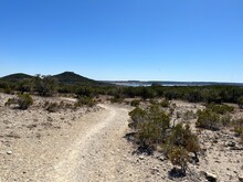A Rocky Footpath And Hiking Trail Located At Dana Peak Park Hike And Bike Trail With Stillhouse Hollow Lake In The Distant Background, Located In Harker Heights Texas A Part Of The Texas Hill Country