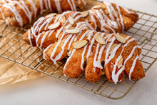 Bear Claw Pastry On A Cooling Rack With Glaze And Almonds