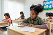 © Kawee - African American student doing exam in classroom at elementary school.