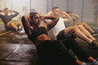 © Flamingo Images - Fit young woman doing sit-ups during a gym exercise class
