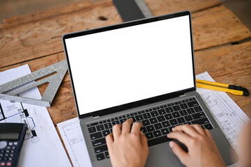 Canvas Print - close-up image of a professional female engineer or architect using laptop in the office.