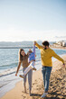 © Westend61 - Father and mother picking up daughter at beach