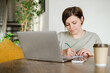 © lelechka - Woman work on laptop at the table. Portrait of smiling woman with computer