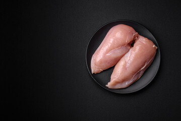 Pieces of raw chicken or turkey fillet with salt, spices and herbs