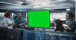 © Gorodenkoff - Group of Multiethnic Software Developers Having a Meeting in a Conference Room with Green Screen Mock Up Display. Specialists Brainstorming New Ideas and Solving Problems in the Office