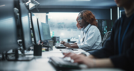 Fototapete - Portrait of a Thoughtful Black Female Engineer Working on Computer in a Technological Office Environment. Research and Development Department Writing Software Code for an Innovative Internet Project