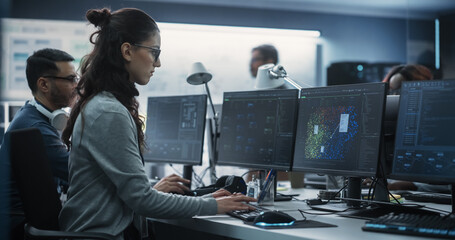 Poster - Young Female Artificial Intelligence Engineer Working on Computer in a Technological Office. Young Specialist Writing Software Code for an Innovative Big Data Blockchain Project. Photo from the Back