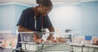 Professional African Nurse Soothing an Adorable Small Caucasian Newborn Child in Nursery Clinic. Medical Health Care, Maternity Hospital and Parenthood Concept