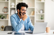 Leinwandbild Motiv Telecommuting Concept. Smiling Indian Man Working Online With Laptop At Home Office Generative AI