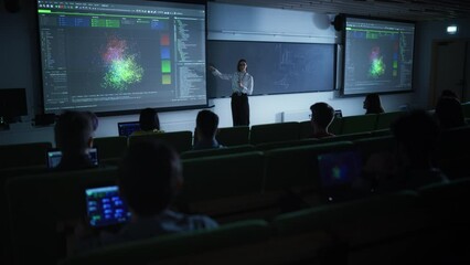 Fototapete - Young Female Teacher Giving a Data Science Lecture to Diverse Multiethnic Group of Female and Male Students in Dark College Room. Projecting Slideshow with Neural Network Model
