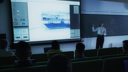 Poster - Young University Professor Explaining an Interior Design Styles Lecture to a Group of Diverse Multiethnic Students in a Dark Auditorium. Female Teacher Showing a Housing Project on Two Big Screens