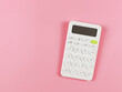 © Phuttharak - flat lay of white calculator on pink background with copy space.