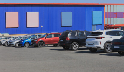 Poster - Cars in a parking lot near a shopping mall