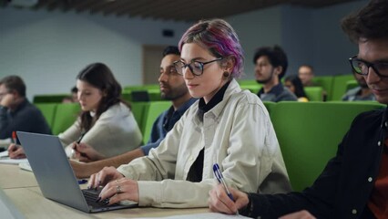 Aufkleber - Smart Creative Female Student Studying in University with Diverse Multiethnic Classmates. Young Woman with Colored Short Hair is Using a Laptop Computer. Taking Notes from a Lecture in College