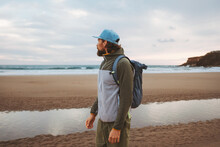 Man Traveling Solo Walking On The Beach With Backpack Healthy Lifestyle Active Summer Vacations Traveler Outdoor Enjoying Sea View