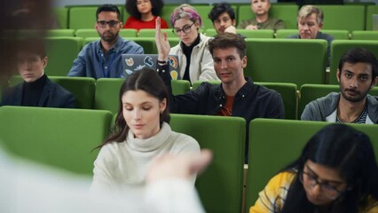 Poster - Smart Diverse Students Studying in College, Listening to an University Professor Giving a Lecture. Enthusiastic Young Man Raising Arm and Answering a Question. Over the Shoulder Footage