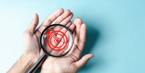Aufkleber - Business hands holding target icon on magnifier, dartboard and arrow for creative and set up business objective target goal, marketing solution, target for business investment.